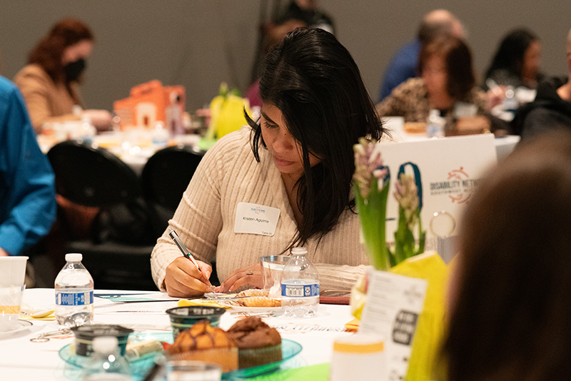 Breakfast attendee completing a pledge form.